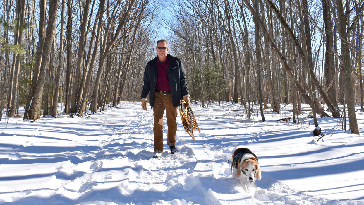 Jason Norton of William Raveis Real Estate walks his dog in Brunswick ME.